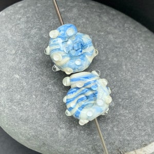 Streaky cream and blue ammonite lampwork glass bead pair