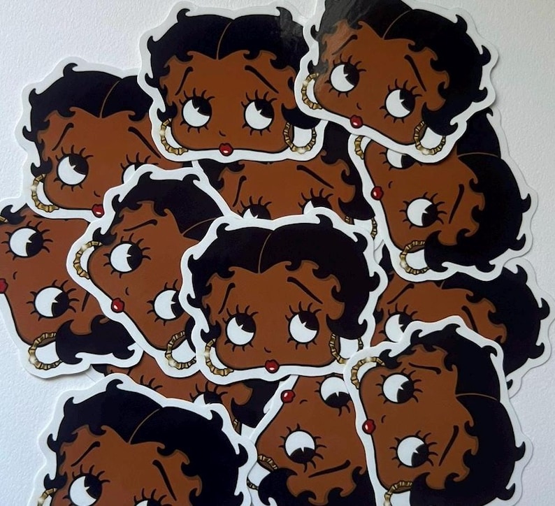 May include: A sheet of stickers featuring multiple cartoon images of a brown-skinned woman with black hair and large eyes. The woman is wearing gold jewelry and has a red lip.