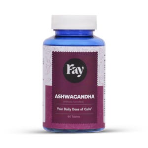 May include: A blue bottle of Fay Ashwagandha tablets. The label is white and purple with the text "Ashwagandha" and "Your Daily Dose of Calm". The bottle contains 60 tablets.
