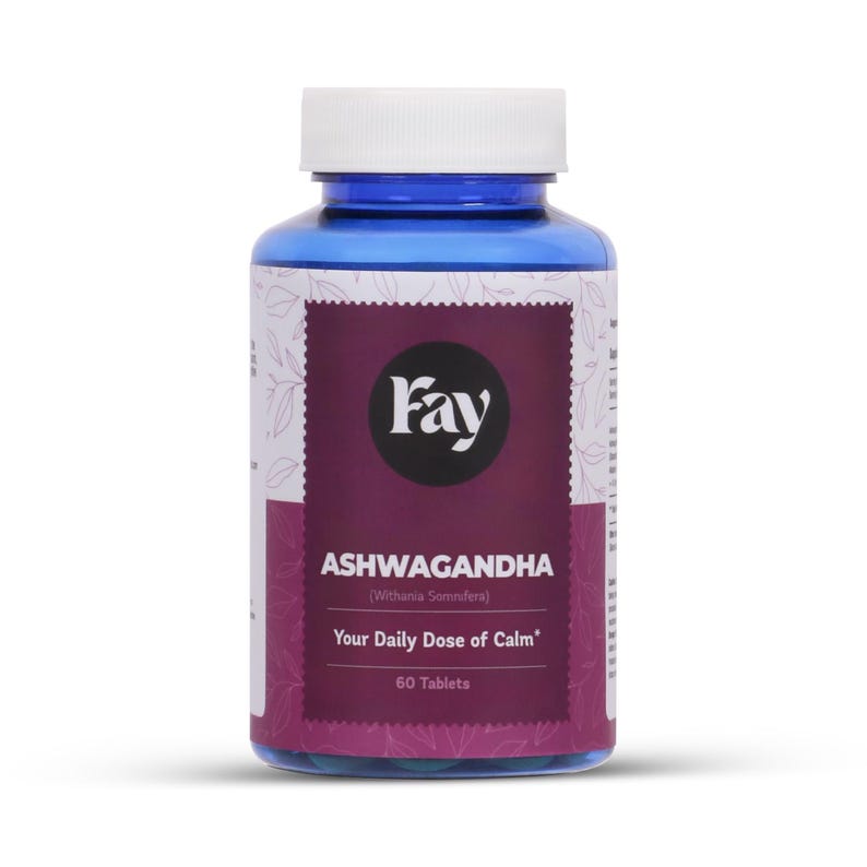 May include: A blue bottle of Fay Ashwagandha tablets. The label is white and purple with the text "Ashwagandha" and "Your Daily Dose of Calm". The bottle contains 60 tablets.