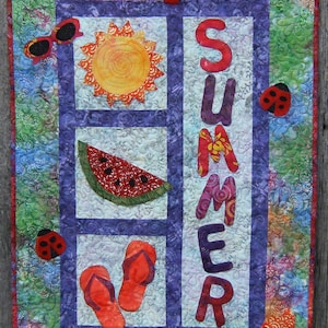 May include: A quilted wall hanging with a summer theme. It features a sun, watermelon slice, flip-flops, and the word "SUMMER" in colorful letters. Ladybug and sunglasses appliqués add to the design.