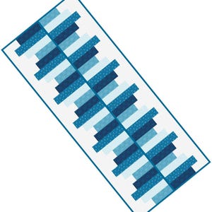 May include: A rectangular, blue and white quilt with a geometric pattern. The design features alternating rows of blue and white rectangles, some with a dotted pattern. The quilt is bordered with a thin blue line.