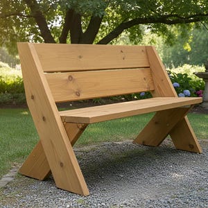May include: A wooden outdoor bench with a slatted back and a seat. The bench is made of light-colored wood and has an X-shaped leg design. It is set on a gravel surface in a garden setting.