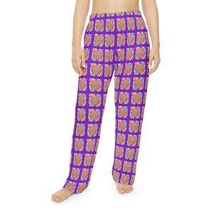 May include: Purple pajama pants with a repeating floral pattern in orange, yellow, and blue. The pants have a relaxed fit and are made of a soft, comfortable material. The floral pattern is arranged in a grid-like design.