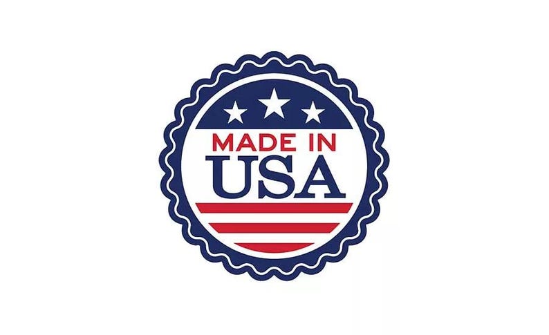 May include: A round emblem with a scalloped edge, featuring the text "MADE IN USA" in red and white, with three white stars above. The design incorporates red and white stripes, set against a white background, and a navy blue border.
