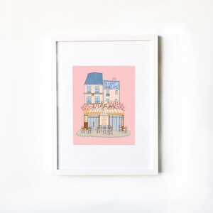 May include: A digital illustration of a Parisian cafe with a pink background. The cafe has a blue awning and a sign that reads "Le Cafe". There are tables and chairs set up outside the cafe.