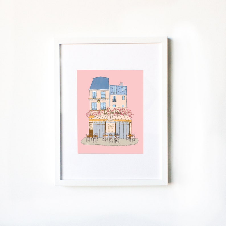 May include: A digital illustration of a Parisian cafe with a pink background. The cafe has a blue awning and a sign that reads "Le Cafe". There are tables and chairs set up outside the cafe.