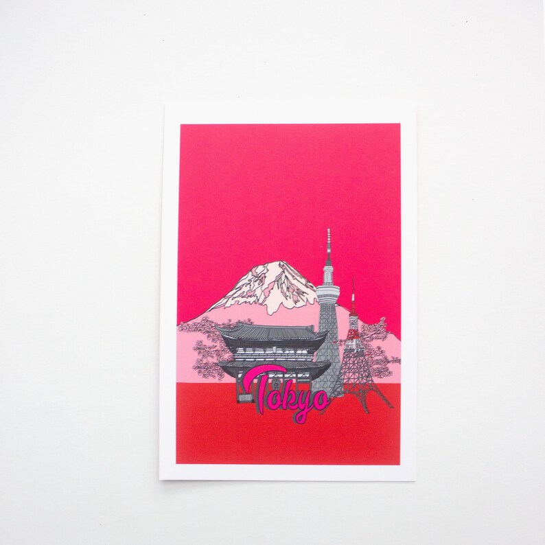 May include: A pink and white illustration of Mount Fuji, a pagoda, and a tower with the word "Tokyo" in pink lettering on a red background.