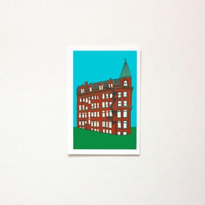 May include: A red brick building with a green roof and a tower. The building has many windows and a fire escape. The building is set against a blue sky.