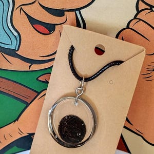 Artificial leather necklace with an ancient Roman coin with beautiful embossing cast in resin
