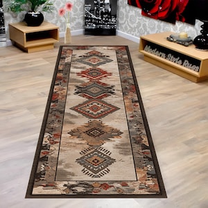 May include: A rectangular runner rug with an intricate geometric pattern in shades of brown, red, and gray. The rug features a central design of diamond and rectangular shapes, bordered by a darker brown trim. The rug is designed for a hallway or entryway.