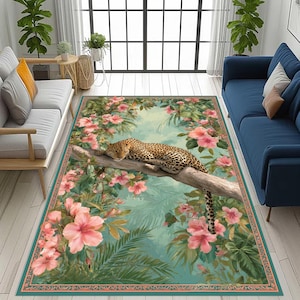 May include: Rectangular rug with a leopard on a branch, framed by pink hibiscus and green leaves. The rug has a teal border with a floral pattern, creating a tropical scene. The rug is suitable for a living room.