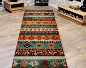 May include: A rectangular area rug with a Southwestern design. The rug features a repeating pattern of geometric shapes in shades of teal, orange, brown, and cream. The rug is made of a durable material and is suitable for high-traffic areas.