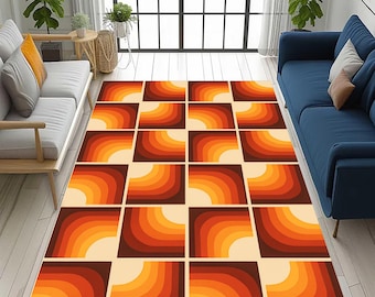 May include: A rectangular area rug with a retro design. The rug features a repeating pattern of squares, each containing a quarter-circle gradient in shades of orange, brown, and cream. The rug is placed on a light-colored wooden floor.