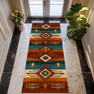 May include: A rectangular runner rug featuring a repeating geometric pattern with diamonds and horizontal stripes in shades of burnt orange, deep teal, cream, and brown. The design includes symmetrical arrow-like motifs and small circular accents.