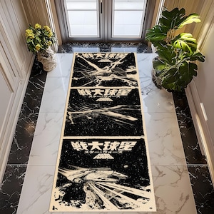 May include: A rectangular black and white Star Wars themed floor mat. The mat features three panels with images of spaceships and Japanese text. The text reads "Star Wars" in English and Japanese. The mat is placed on a marble tile floor.