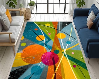 May include: A colorful abstract area rug with a modern design. The rug features a vibrant mix of colors, including blue, orange, yellow, green, and pink, with intersecting lines and circular shapes. The rug is rectangular and placed on a light-colored wooden floor.