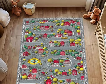 May include: A rectangular children's play rug featuring a town map design. The rug has a gray background with roads, buildings, trees, and yellow cars. Red houses and green trees are scattered throughout the town. The rug is bordered with a decorative pattern.