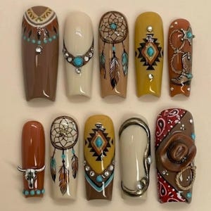 May include: A set of ten long, square-shaped artificial nails with a Western and Native American theme. Designs include dream catchers, turquoise accents, geometric patterns, a cowboy boot, and a steer skull. Colors include brown, beige, yellow, and red.