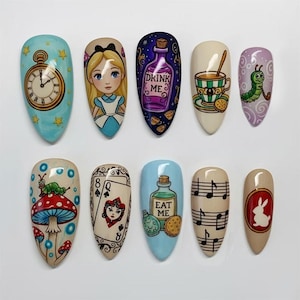May include: A set of ten almond-shaped nail art designs featuring illustrations from Alice in Wonderland. Designs include a pocket watch, Alice, a potion bottle with "DRINK ME", a teacup, a caterpillar, a mushroom, playing card, a bottle with "EAT ME", musical notes, and a white rabbit.