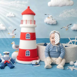 May include: A nautical-themed scene with a red and white lighthouse, seagulls, and fluffy clouds. A baby in a sailor outfit sits near a white basket. A toy sailor doll and a ship's wheel complete the scene.