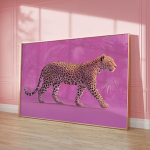 May include: Framed artwork featuring a leopard walking to the right. The leopard has a tan coat with black spots. The background is a pinkish-purple with a palm leaf design. The frame is gold.
