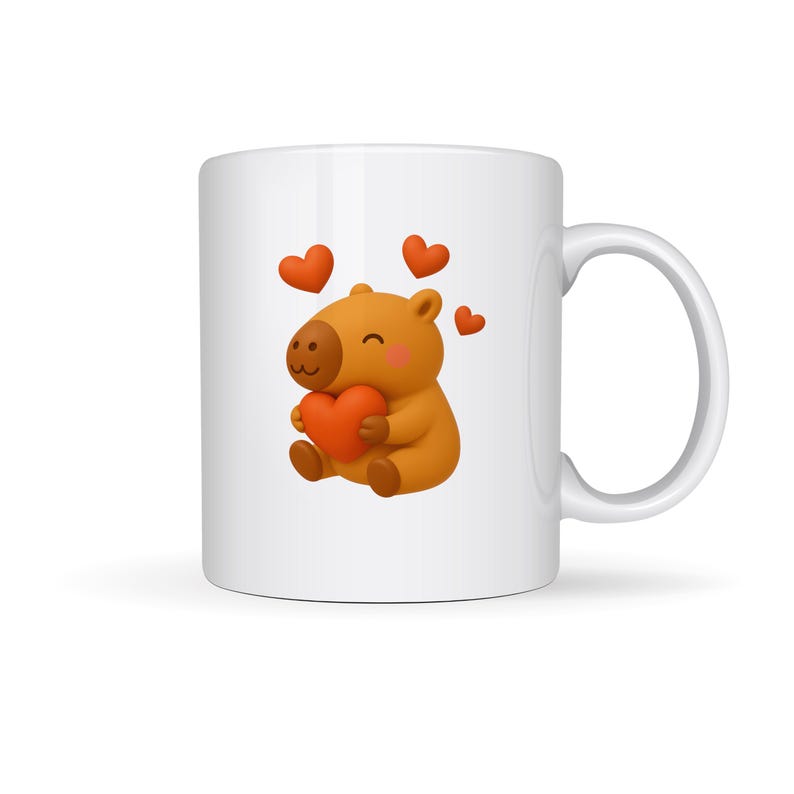 May include: White ceramic mug featuring a cartoon capybara holding a red heart. The capybara is brown with a dark brown nose and is surrounded by three floating red hearts. The mug has a white handle.