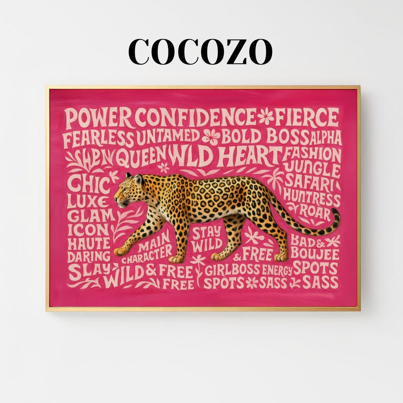 May include: A framed print with a pink background and a gold frame. The print features a leopard illustration with the words "Power, Confidence, Fierce, Wild" and other empowering words. The brand name "COCOZO" is at the top.