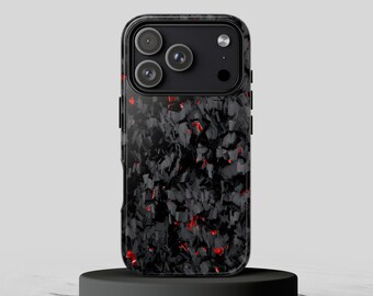 May include: A smartphone case featuring a dark, fragmented carbon fiber pattern with scattered, vibrant red accents. The case has a rectangular cutout at the top for a triple-lens camera system and a flash, maintaining a sleek, modern appearance.