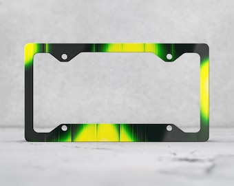 May include: A rectangular license plate frame featuring a vibrant gradient pattern that transitions between bright yellow, lime green, and deep black. The design includes vertical line textures throughout, with four circular mounting holes.