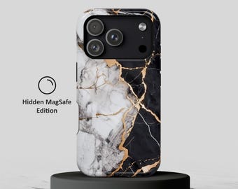 May include: A smartphone case featuring a split design of white and black marble patterns with gold veining. The camera module area is black with three circular lenses. Text on the left reads Hidden MagSafe Edition with a circle icon.