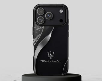 May include: A black smartphone case featuring a silver Maserati trident logo and script text. The design includes a curved silver metallic accent along the left side with a marbled pattern, contrasting against the matte black finish of the case.