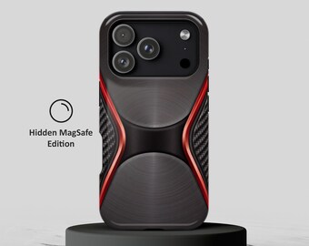 May include: A dark gray and black phone case with a brushed metal texture, carbon fiber side panels, and red accents. The case features a triple camera cutout and the text Hidden MagSafe Edition with a circular icon to the left side.