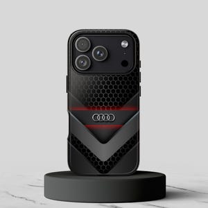 May include: Black phone case with a honeycomb pattern and a gray chevron design. The case features the Audi logo and red accent lines. The phone case is displayed on a black pedestal.