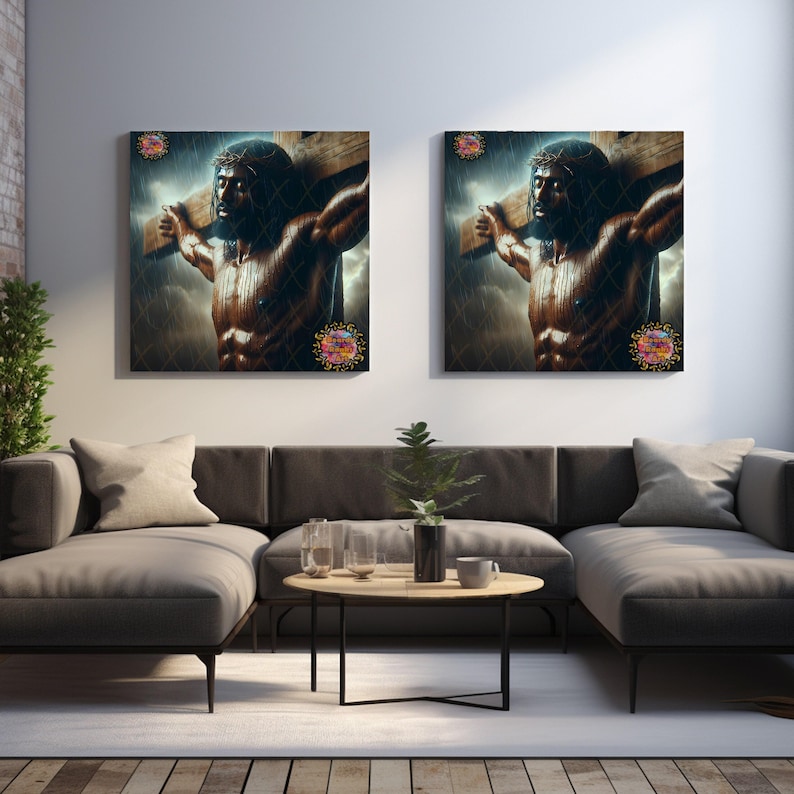 May include: Two framed wall art pieces showing a muscular figure bearing a wooden cross, set against a stormy sky. The artwork uses a dark colour palette with detailed shading. The pieces are displayed above a grey sofa in a modern living room setting.