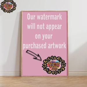May include: A framed pink artwork with the text "Our watermark will not appear on your purchased artwork." The artwork has a logo in the bottom right corner and a logo in the top left corner. The frame is a light brown colour.