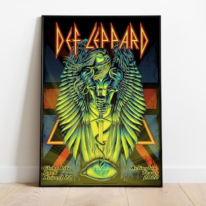 May include: Framed Def Leppard concert poster. The artwork features a stylized winged figure in shades of green and yellow, with the band's logo at the top. The poster includes the venue, date, and location: Globe Life Park, Arlington, Texas, August 22, 2022.