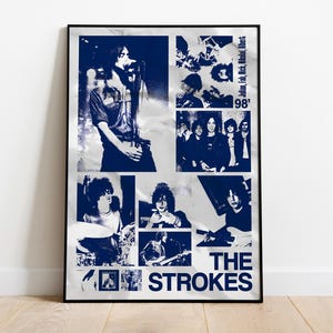 May include: A framed poster featuring a collage of images of the band The Strokes in shades of blue and white. The poster includes the band's name and the year '98'. The images show the band members performing.