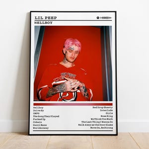 May include: Framed poster featuring Lil Peep's album "Hellboy." The image shows Lil Peep with pink hair, wearing a red jersey. The poster includes the album title, tracklist, and a Spotify code. The background is a vibrant red.