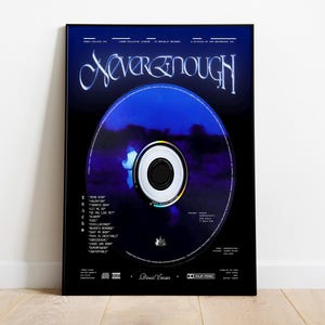 May include: A framed poster featuring a CD design with the title "Never Enough" in a stylized font. The CD is a gradient of blue and purple, with a black border. The poster includes a tracklist and other details.