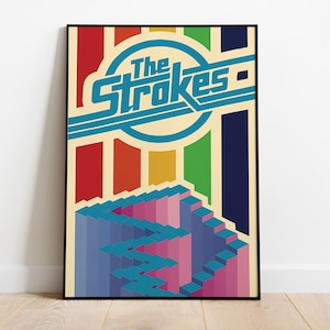 May include: A framed poster with the band name "The Strokes" in turquoise. The design features a geometric staircase and vertical stripes in red, orange, yellow, green, and blue. The background is cream-colored.