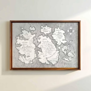 May include: A framed map with a dark wood frame. The map is a fantasy illustration in black and white, depicting islands with names like 'Kerzoae' and 'Desolation'. A compass rose is in the upper right corner. The text 'The Lost Isles of Time' is visible.