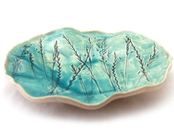 Large turquoise fruit bowl, with swirling grasses