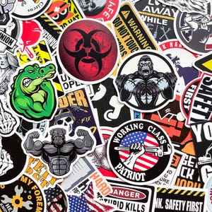 May include: A selection of vibrant stickers featuring diverse designs. Includes a green alligator flexing, a red biohazard symbol, a gorilla lifting weights, and a muscular dog. Other stickers display text such as "Working Class Patriot" and "Danger".