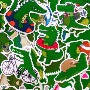 May include: A collection of green alligator stickers in various poses. Some alligators are riding a bicycle, floating on a pool float, or wearing a watermelon-themed inner tube. Other stickers show alligators playing golf or with a sloth.