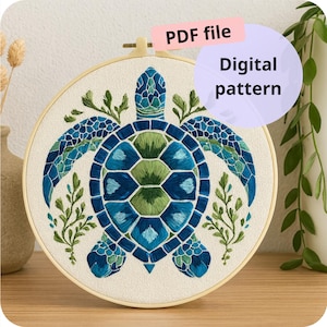 May include: Embroidered sea turtle design in a wooden hoop. The turtle is rendered in shades of blue and green, with detailed stitching. The text "PDF file" and "Digital pattern" are visible.