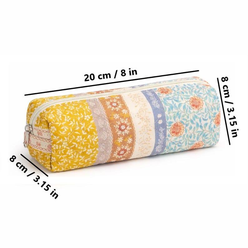 May include: A cylindrical pencil case, 8 inches long and 3.15 inches in diameter, with a zipper closure. The case features a patchwork design with floral and lace patterns in yellow, brown, blue, and white. The case is 8 inches long and 3.15 inches in diameter.