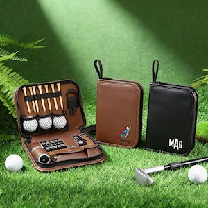 May include: A brown leather golf kit with golf tees, golf balls, and accessories, next to two zippered cases, one brown with a superhero graphic and the name "Henry", and one black with the initials "MAG". A golf club and ball are also visible.
