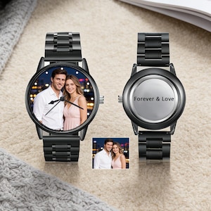 May include: Two black wristwatches. One watch face displays a colour photo of a couple, the other watch face has the words "Forever & Love". Both watches have black metal straps. A small photo of the couple is at the bottom.
