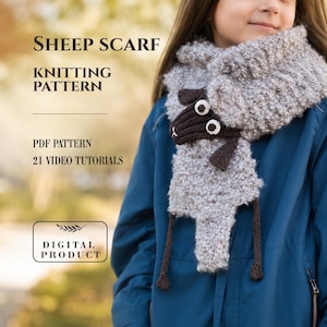 May include: A grey textured sheep scarf knitting pattern featuring a dark brown sheep head with white eyes and dangling legs. The text reads: SHEEP SCARF KNITTING PATTERN, PDF PATTERN, 21 VIDEO TUTORIALS, DIGITAL PRODUCT. This is a digital knitting guide.